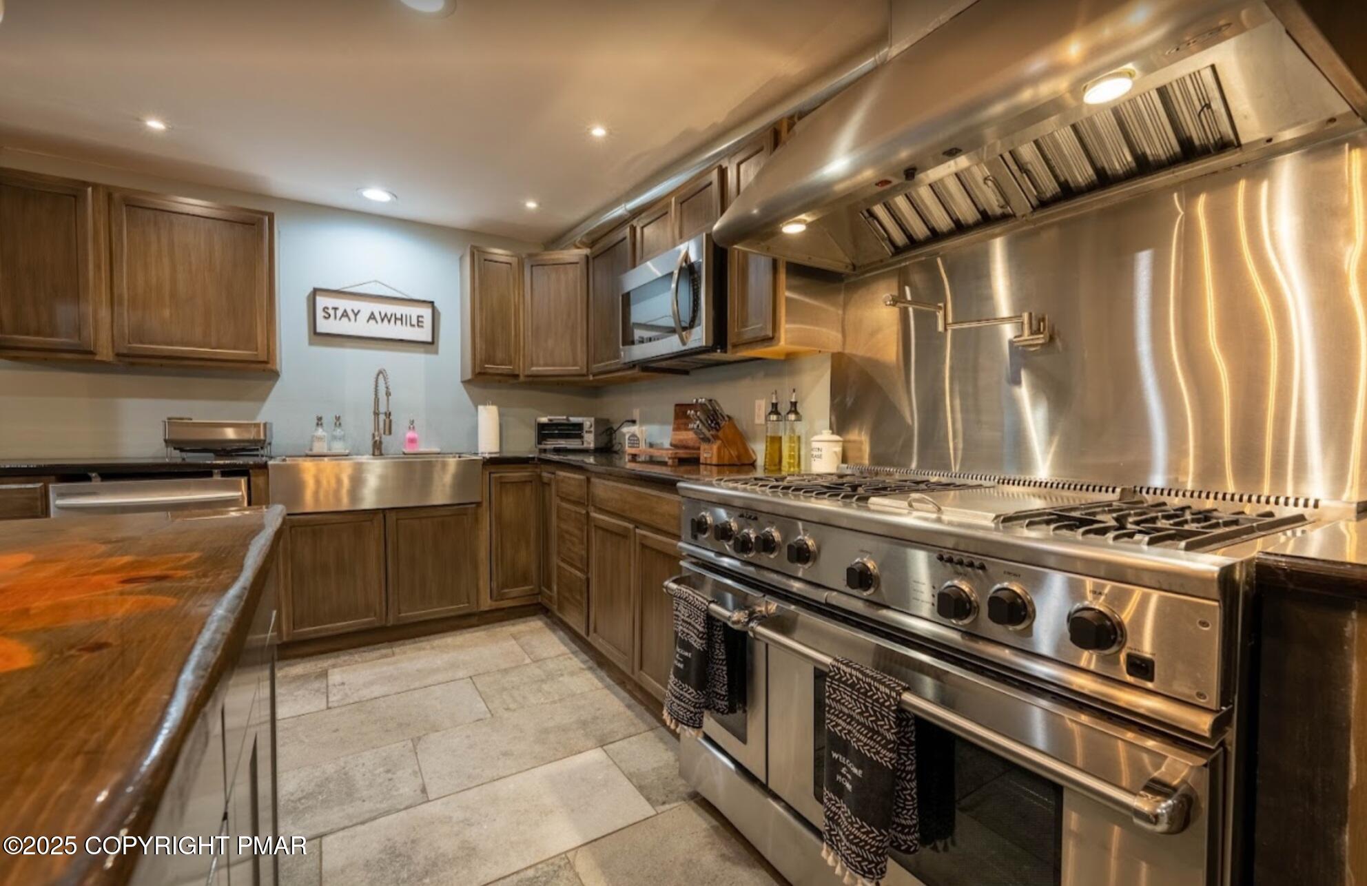 2735 Highway 390 Canadensis, PA 18325 - Photo 10 of 55 a kitchen with stainless steel appliances granite countertop a stove a sink dishwasher and a refrigerator