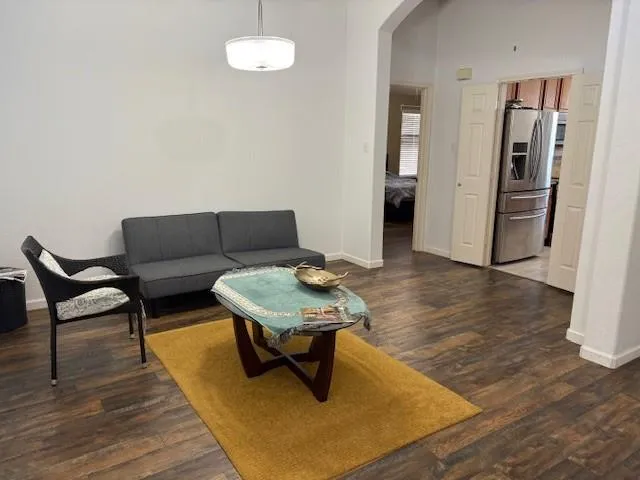 a living room with furniture rug and a table