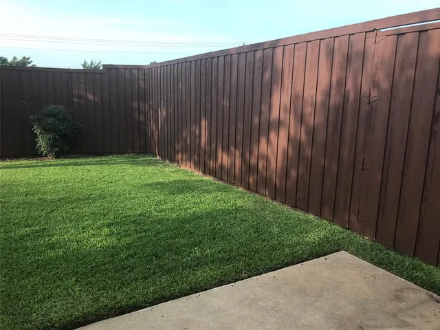 an aerial view of a house roof deck with chairs and a table