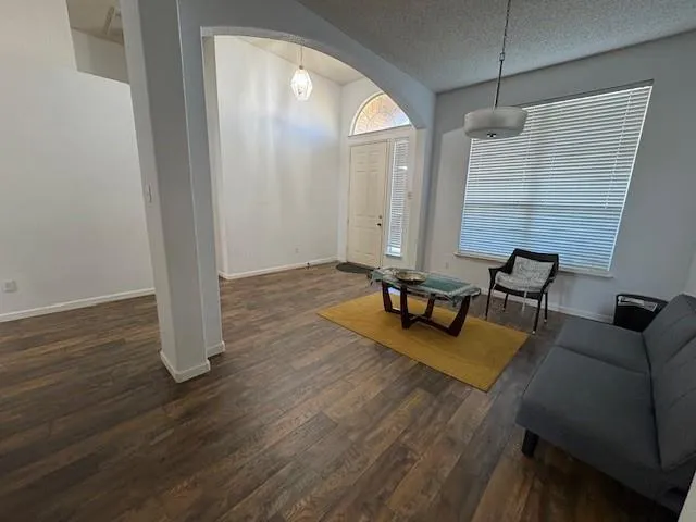 a living room with furniture and wooden floor