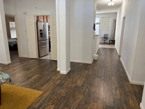 a view of a hallway with wooden floor