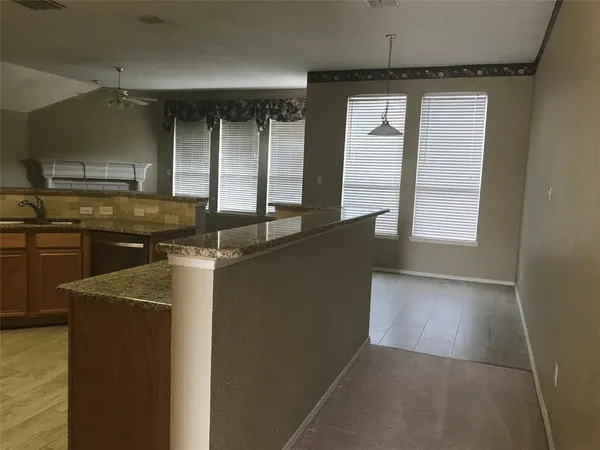 a kitchen with a sink a counter top space and cabinets