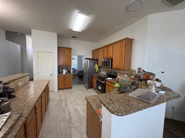 a kitchen with a sink stove and refrigerator