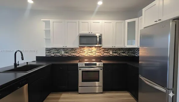 a kitchen with a sink stove and refrigerator