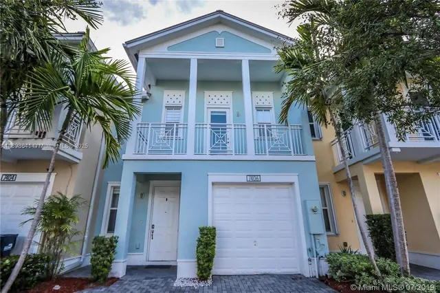 front view of a house with a tree