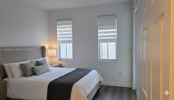 a bedroom with a bed and window