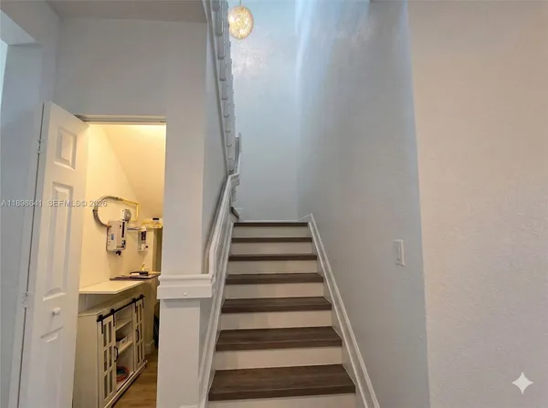 a view of entryway and hall with wooden floor