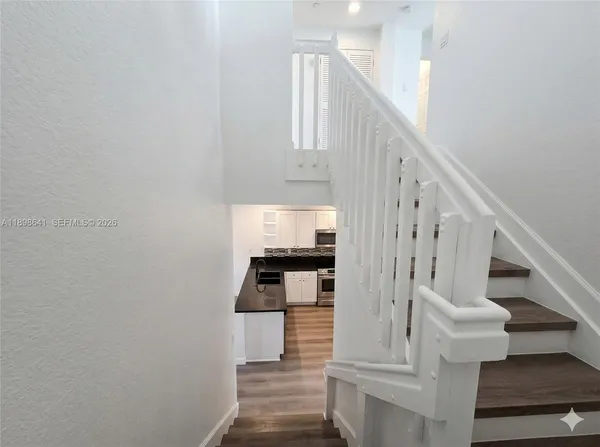 a view of entryway and hall with wooden floor