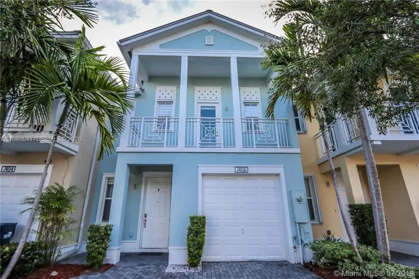 front view of a house with a tree