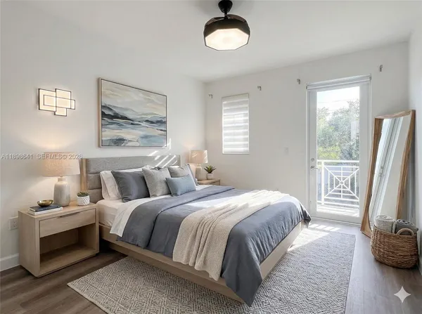 a bedroom with a bed and a large window