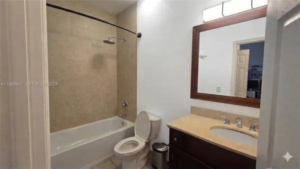 a bathroom with a sink toilet tub and shower