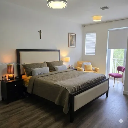 a bedroom with a bed and window