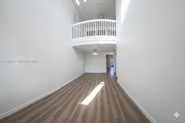 a view of bedroom with wooden floor