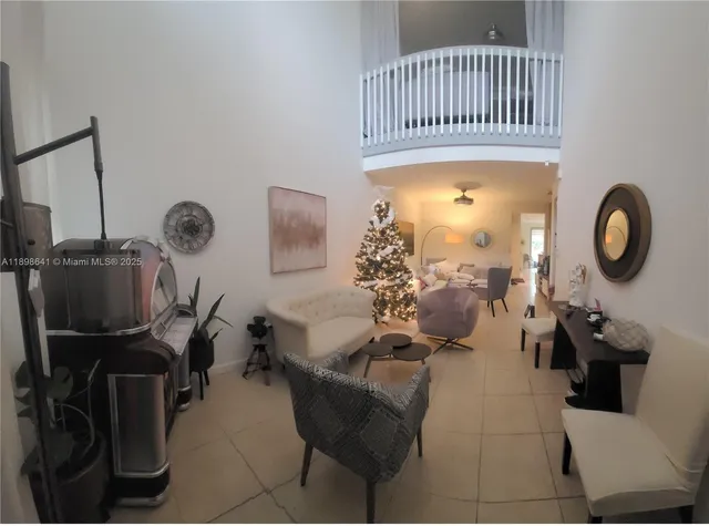 a living room with furniture a window and a wooden floor