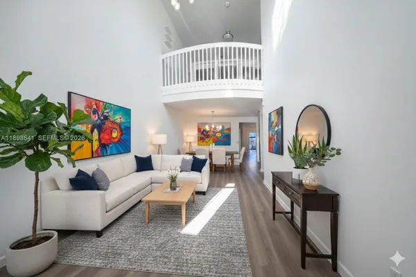 a living room with furniture a rug and a window