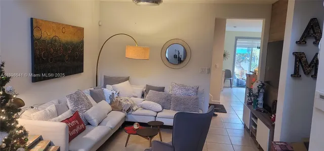 a living room with furniture and a mirror