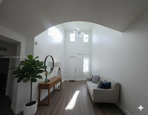 a living room with furniture and a potted plant