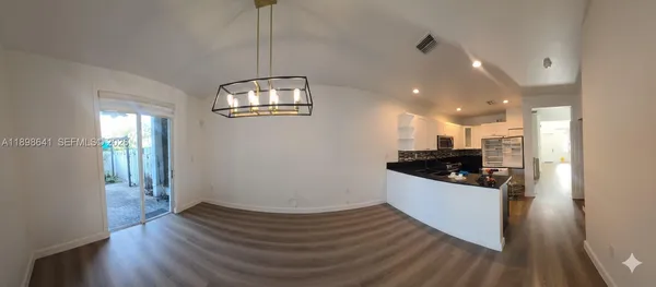 a kitchen with stainless steel appliances a refrigerator sink and stove