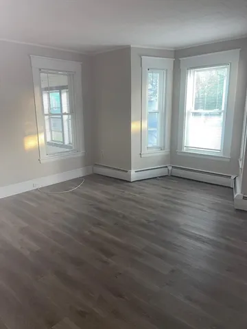a view of a livingroom with an empty space and a window