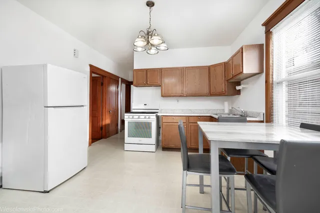an empty room with window and wooden floor