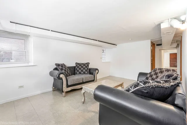 a view of a white house with a snow in the yard