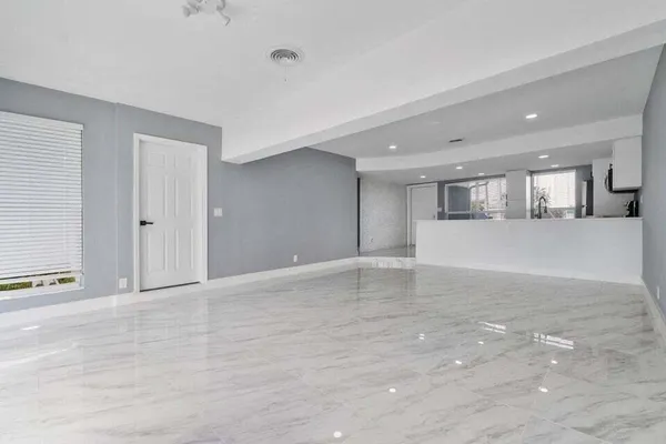 a view of a kitchen with a sink and cabinets