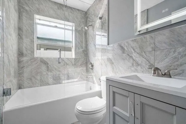 a bathroom with a sink a toilet and a bathtub