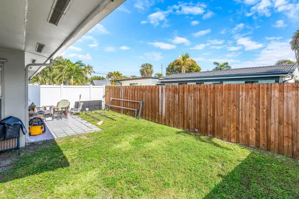 a view of backyard with seating area and green space