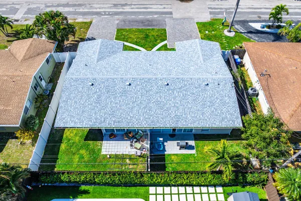an aerial view of a house with yard