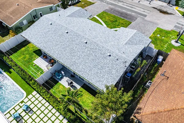 an aerial view of a house with a yard