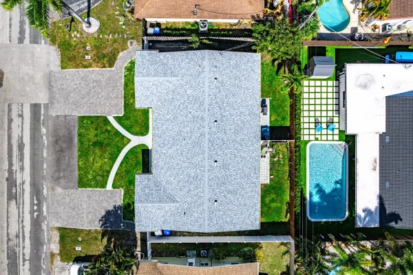 an aerial view of a house with a yard