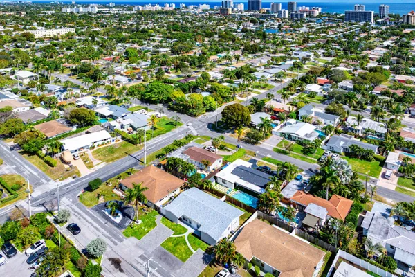 an aerial view of residential houses with outdoor space and street view