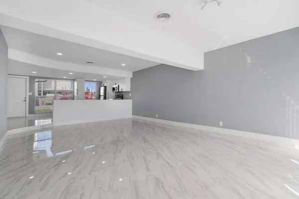 a view of a kitchen with a sink and wooden floor