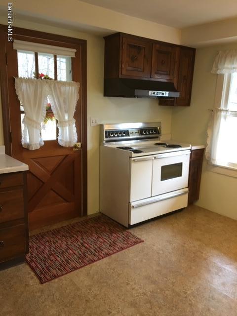 55 Cross Road Clarksburg, MA 01247 - Photo 7 of 22 a kitchen with stainless steel appliances granite countertop a stove a sink and a microwave