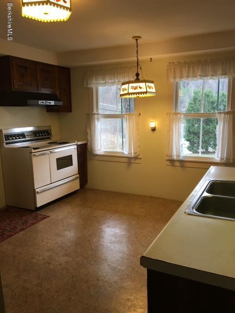 55 Cross Road Clarksburg, MA 01247 - Photo 8 of 22 a kitchen that has a sink stainless steel appliances a window and a counter top space