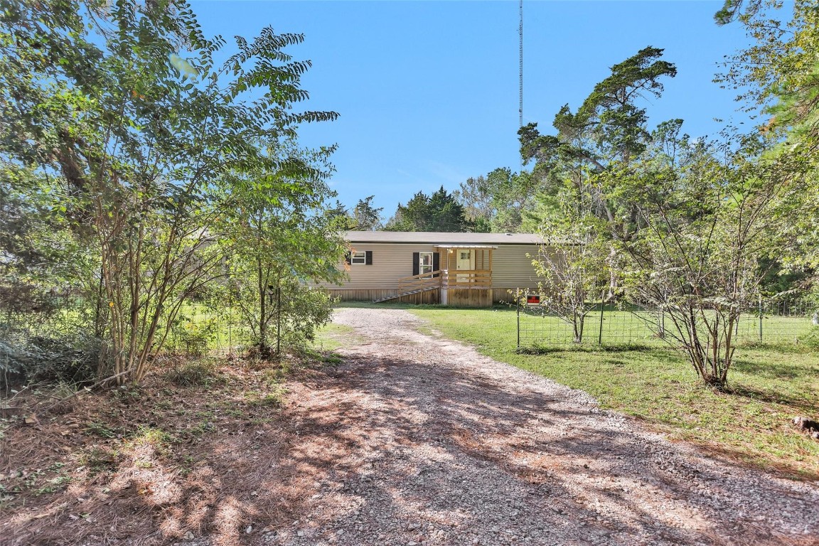 a view of house with backyard and trees