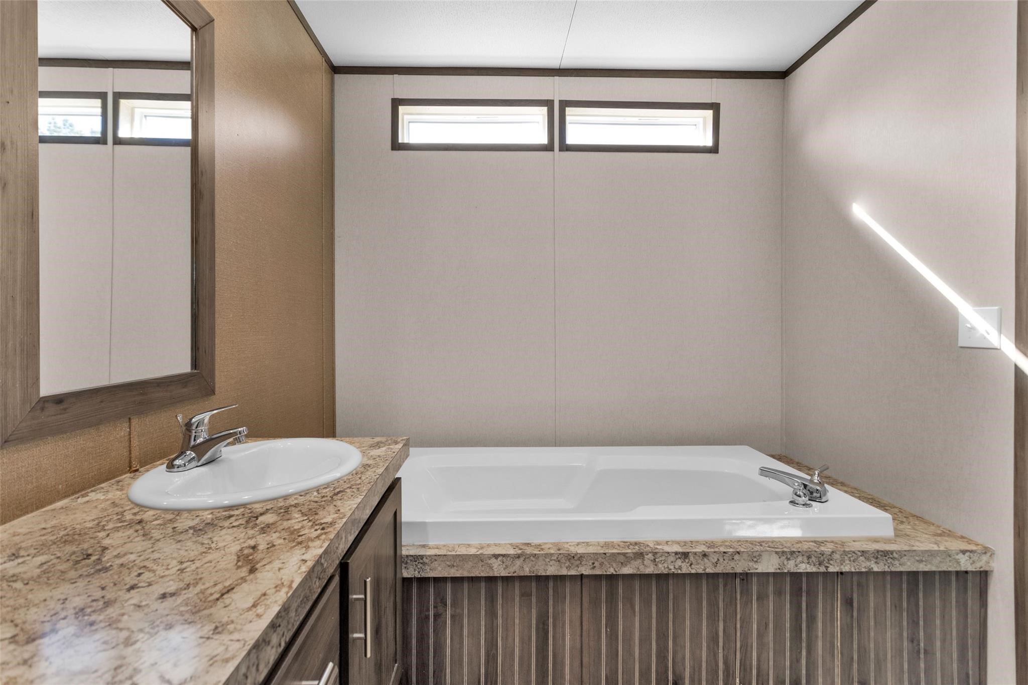 10161 Pollard Road, Unit 1 Willis, TX 77318 - Photo 11 of 22 a bathroom with a granite countertop sink and a mirror
