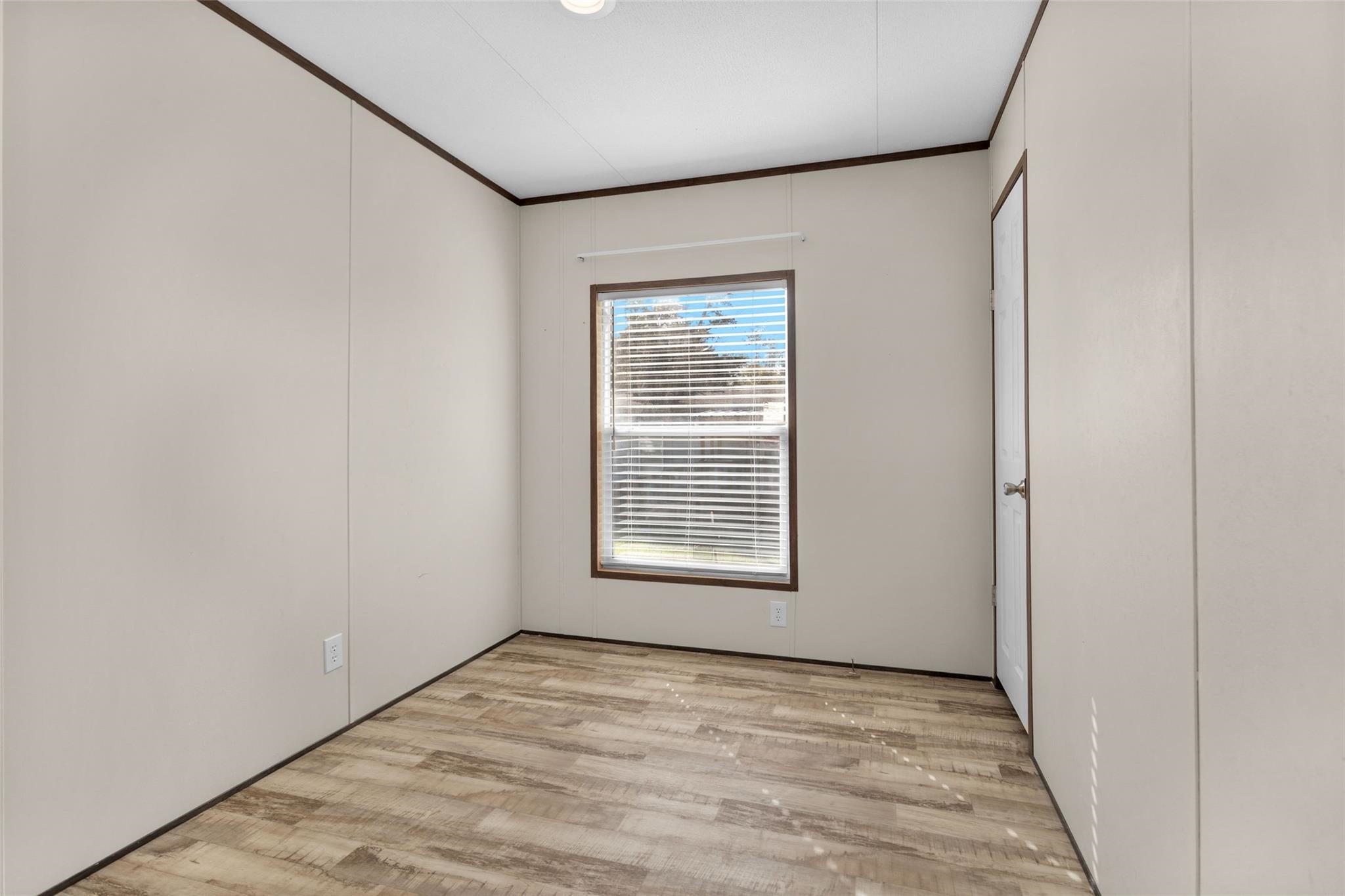 10161 Pollard Road, Unit 1 Willis, TX 77318 - Photo 14 of 22 a view of an empty room with wooden floor and a window