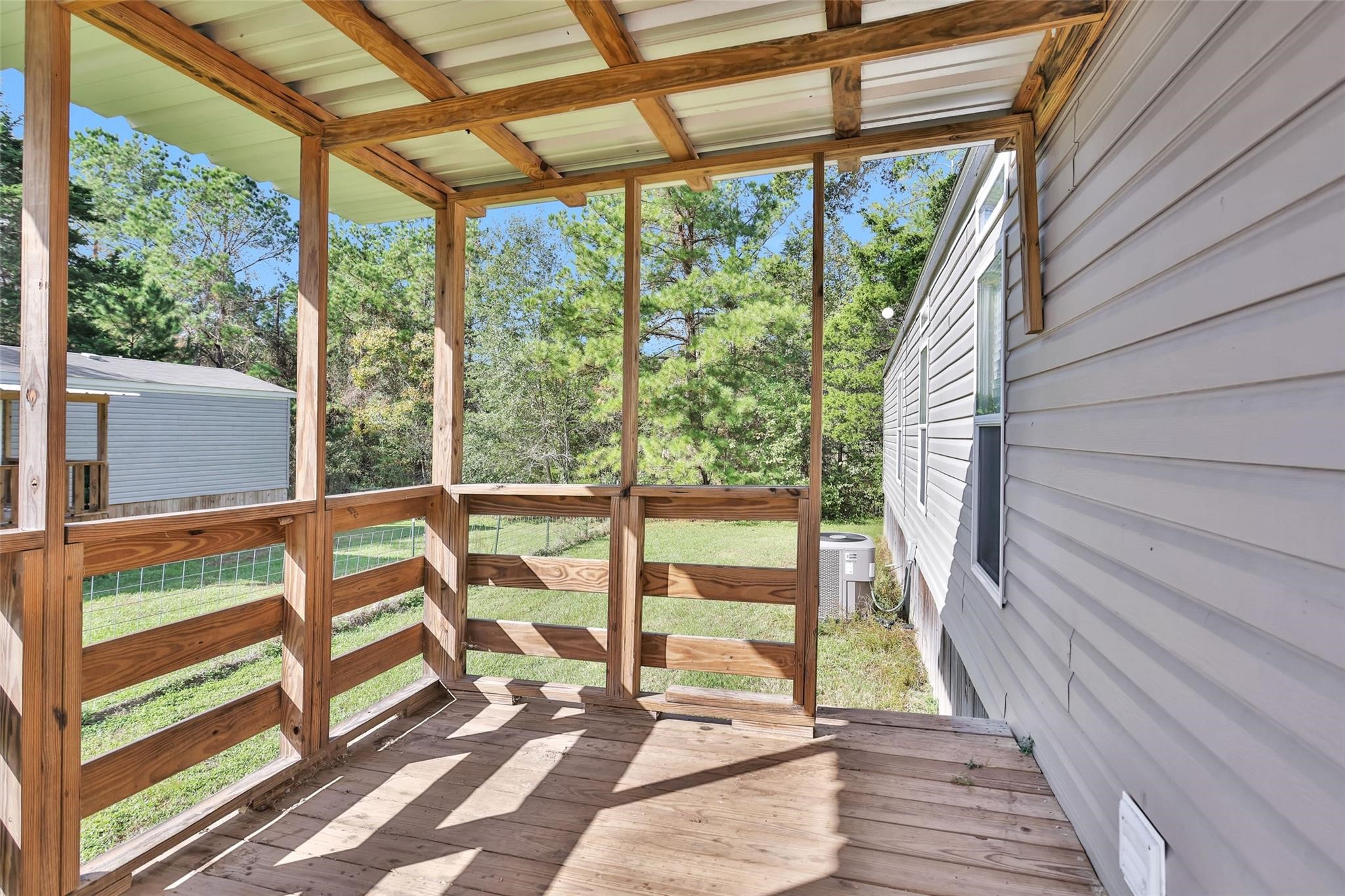 10161 Pollard Road, Unit 1 Willis, TX 77318 - Photo 21 of 22 a view of a balcony with wooden floor and outdoor space