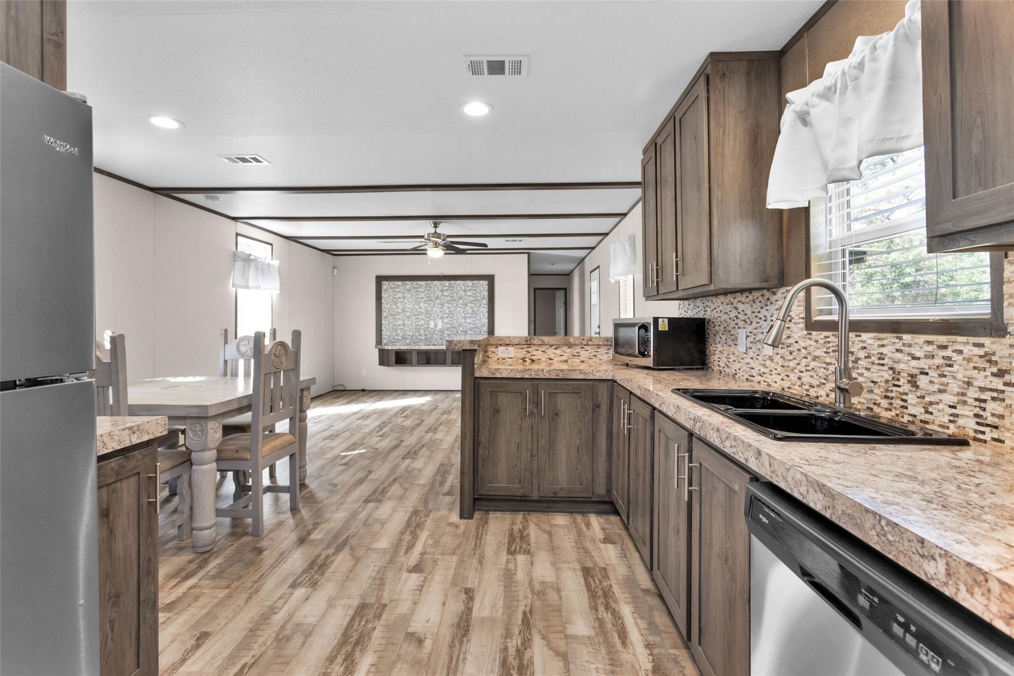 10161 Pollard Road, Unit 1 Willis, TX 77318 - Photo 5 of 22 a kitchen with a sink a counter top space and appliances