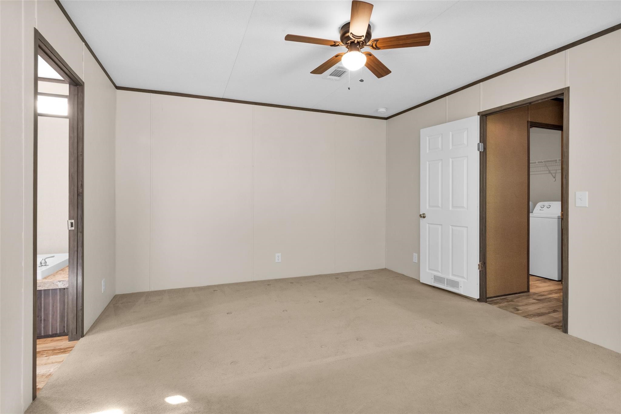 10161 Pollard Road, Unit 1 Willis, TX 77318 - Photo 9 of 22 an empty room with a ceiling fan and a window