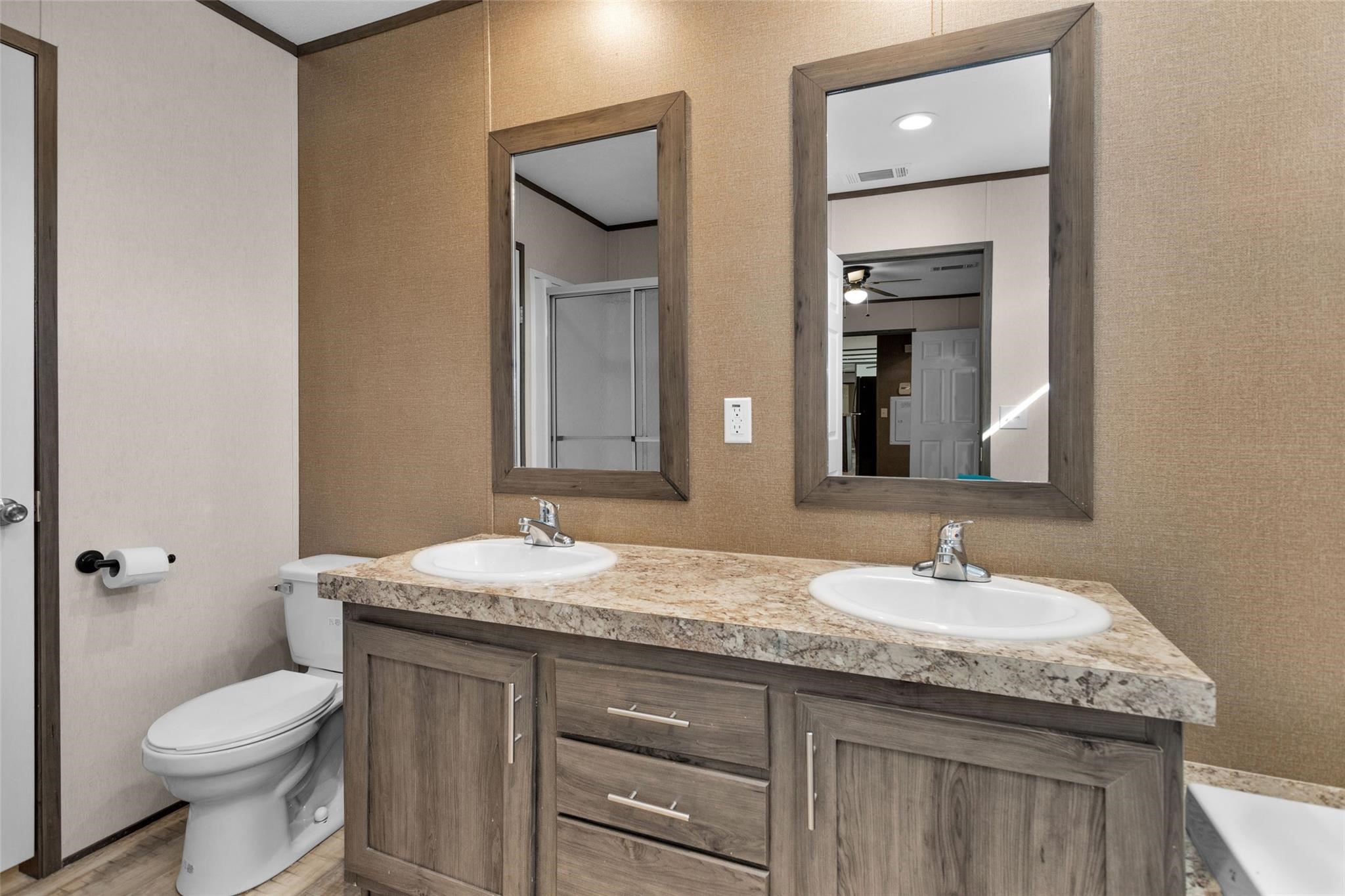 10161 Pollard Road, Unit 1 Willis, TX 77318 - Photo 10 of 22 a bathroom with a granite countertop sink a toilet and a mirror