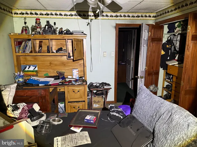 a view of a hallway with large windows and closet