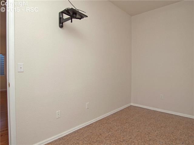 8756 Del Rio Road Peyton, CO 80831 - Photo 21 of 31 Exercise Room in the basement has vinyl floors and TV mount.