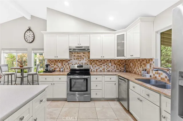a kitchen with a stove top oven sink and cabinets