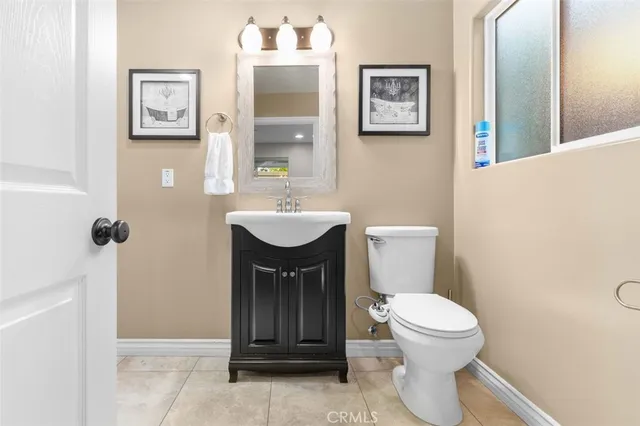 a white toilet sitting next to a bathroom sink