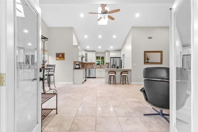 a kitchen with stainless steel appliances kitchen island granite countertop a refrigerator and cabinets