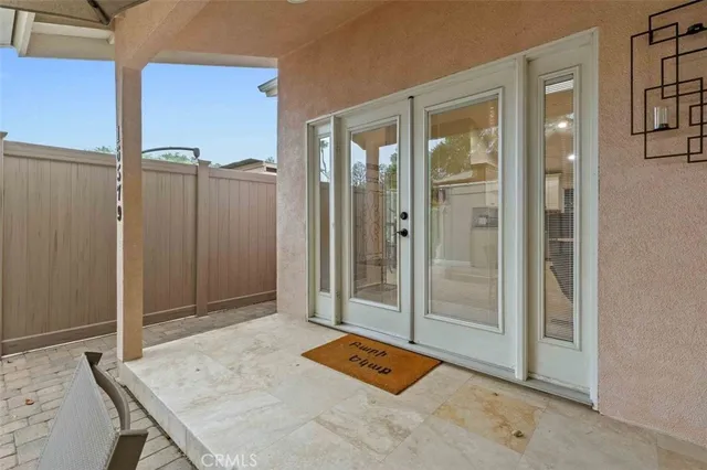 a view of a hallway to a livingroom with furniture