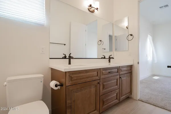 a bathroom with a sink toilet and mirror