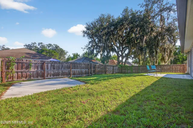 a view of a house with a yard and sitting area